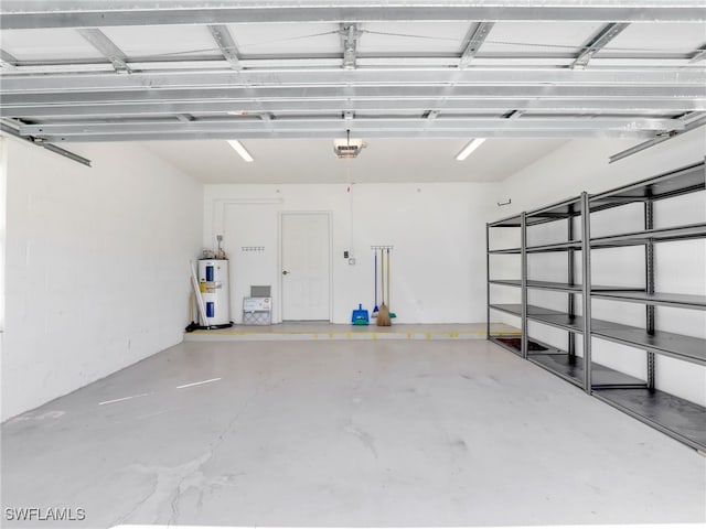 garage with water heater and a garage door opener