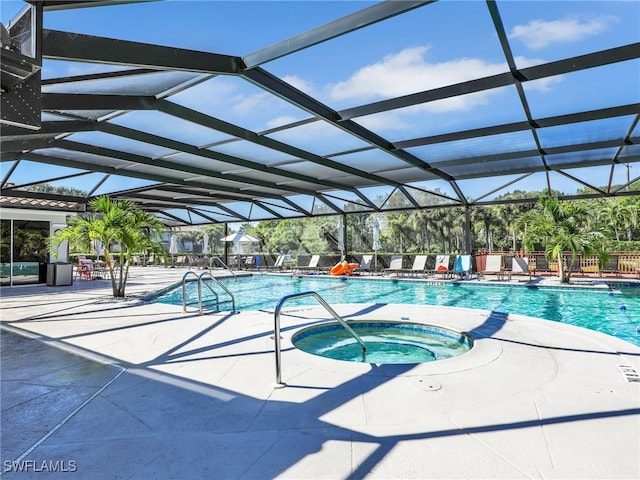 pool featuring a lanai, a community hot tub, and a patio