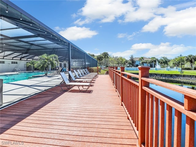 dock area featuring a lanai, a patio area, and a community pool