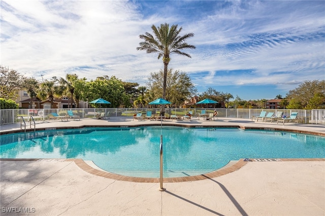 pool with fence and a patio
