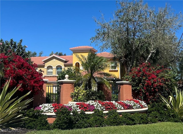 mediterranean / spanish home with stucco siding and fence