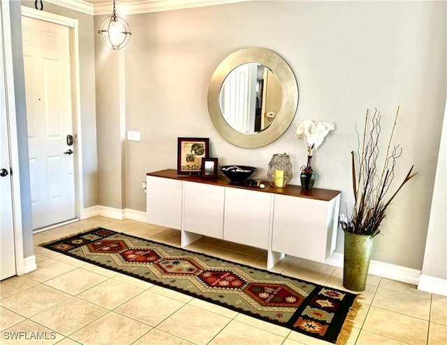 entryway with ornamental molding, baseboards, and light tile patterned floors
