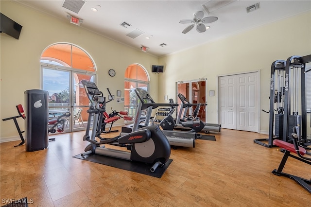 gym featuring baseboards, visible vents, and crown molding