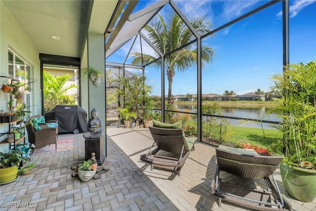 sunroom / solarium featuring a water view