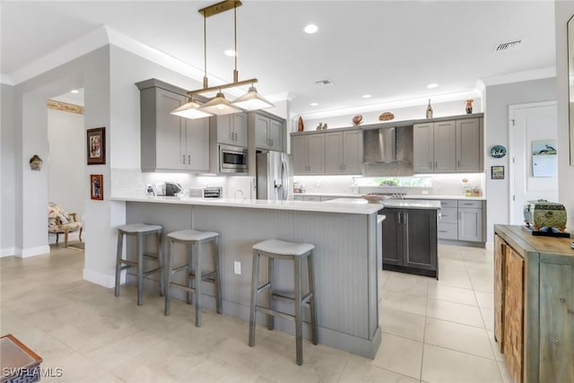 28589 Wharton Dr, Bonita Springs, FL 34135 - kitchen with visible vents, wall chimney range hood, appliances with stainless steel finishes, and gray cabinetry