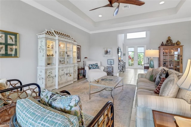 28589 Wharton Dr, Bonita Springs, FL 34135 - living room with a tray ceiling, a ceiling fan, visible vents, and tile patterned floors