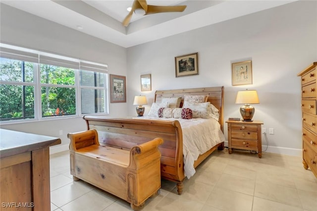 28589 Wharton Dr, Bonita Springs, FL 34135 - bedroom with light tile patterned floors, ceiling fan, a raised ceiling, and baseboards