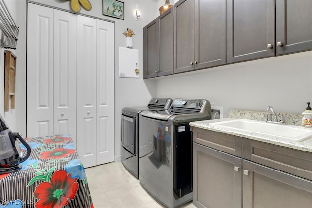 28589 Wharton Dr, Bonita Springs, FL 34135 - washroom featuring cabinet space, a sink, and washing machine and clothes dryer