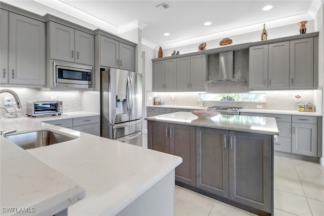 28589 Wharton Dr, Bonita Springs, FL 34135 - kitchen featuring gray cabinets, visible vents, appliances with stainless steel finishes, a sink, and wall chimney range hood