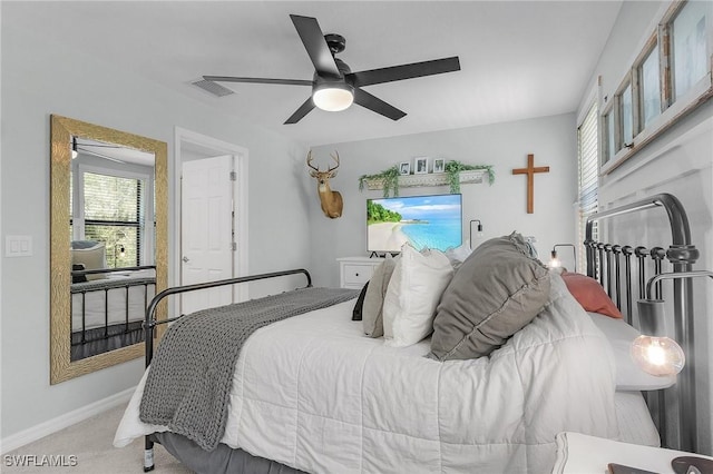 carpeted bedroom featuring a ceiling fan, baseboards, and visible vents