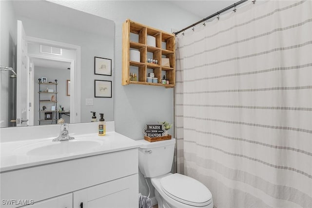 bathroom featuring vanity, curtained shower, toilet, and visible vents