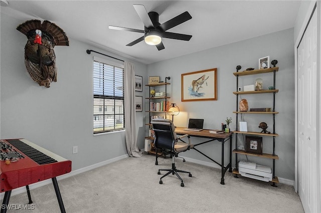 carpeted office with baseboards and ceiling fan