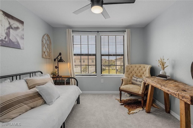 carpeted bedroom featuring baseboards and a ceiling fan