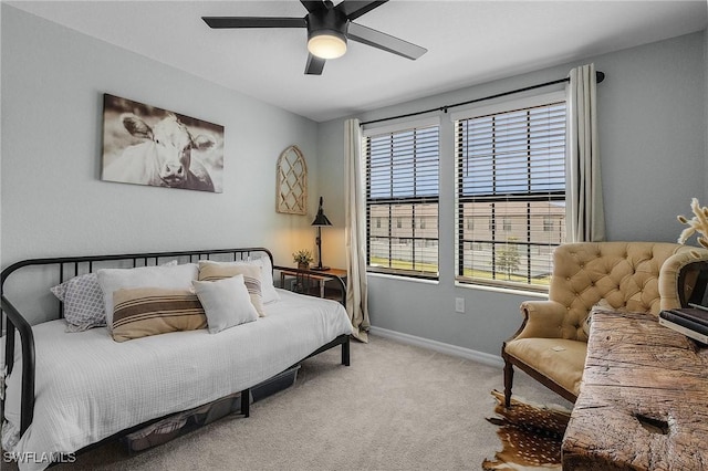 carpeted bedroom with baseboards and a ceiling fan