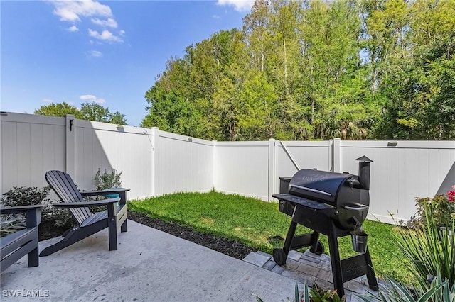 view of patio with area for grilling and a fenced backyard