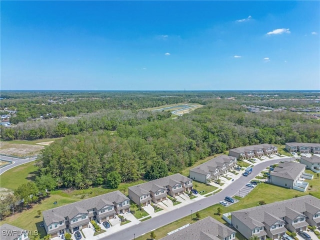 aerial view featuring a residential view and a wooded view