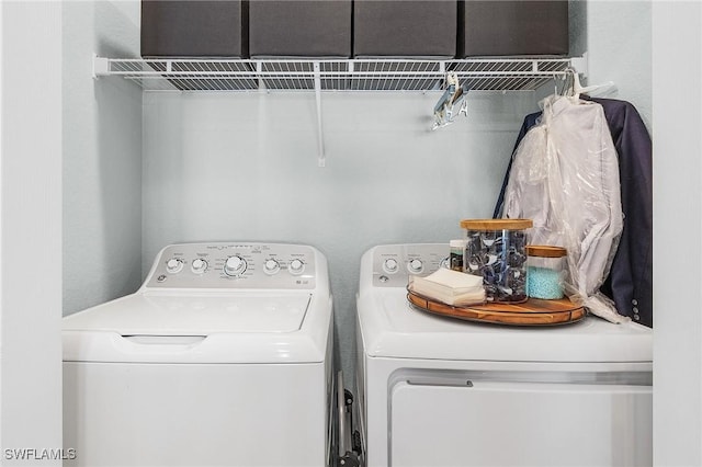 washroom with washing machine and clothes dryer and laundry area