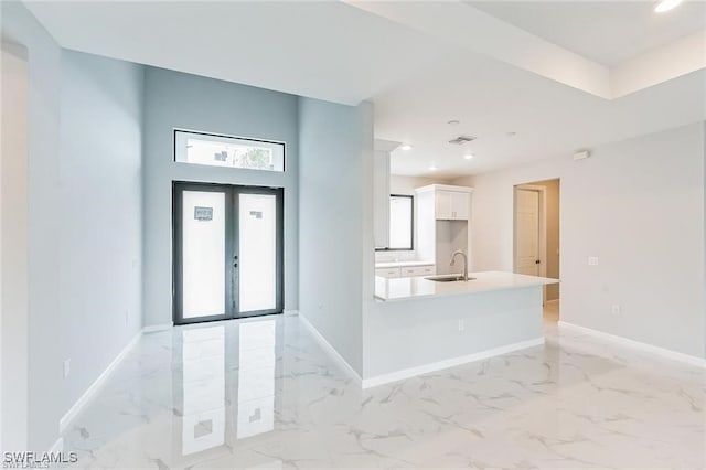 foyer entrance featuring marble finish floor, french doors, recessed lighting, and baseboards