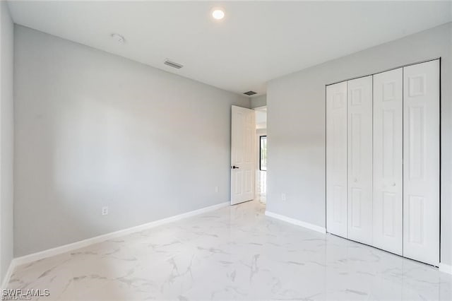 unfurnished bedroom featuring recessed lighting, visible vents, baseboards, marble finish floor, and a closet