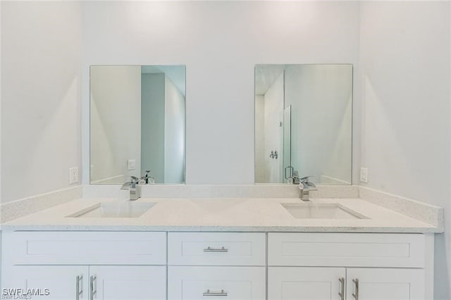 bathroom featuring double vanity and a sink