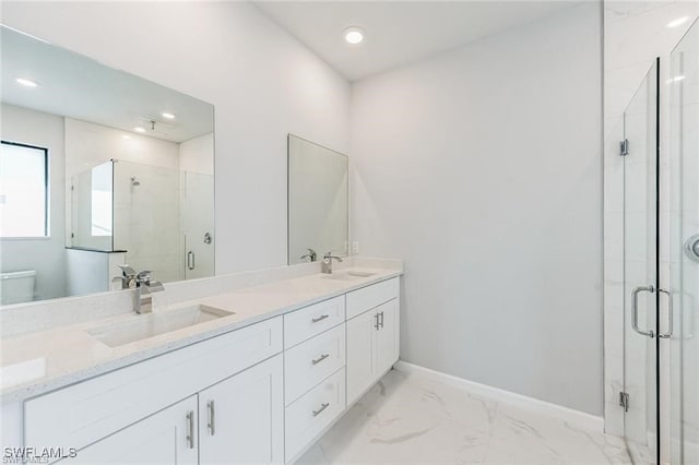 full bath with marble finish floor, a sink, a shower stall, and baseboards