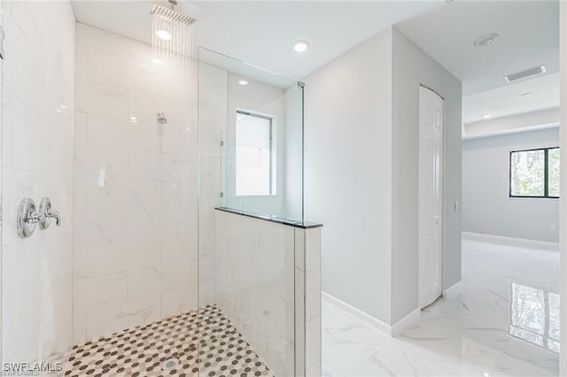 full bathroom with marble finish floor, baseboards, visible vents, and tiled shower