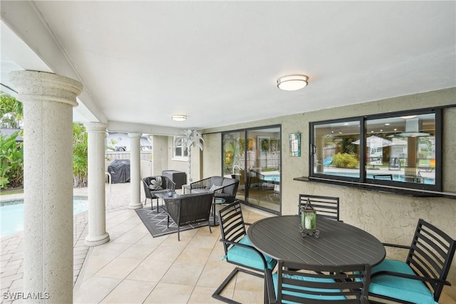 view of patio with a swimming pool and outdoor dining area