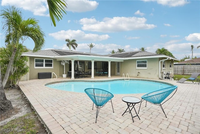 view of swimming pool featuring a patio area, fence, and a fenced in pool