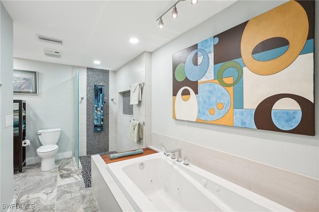 bathroom with visible vents, toilet, a shower stall, a whirlpool tub, and baseboards