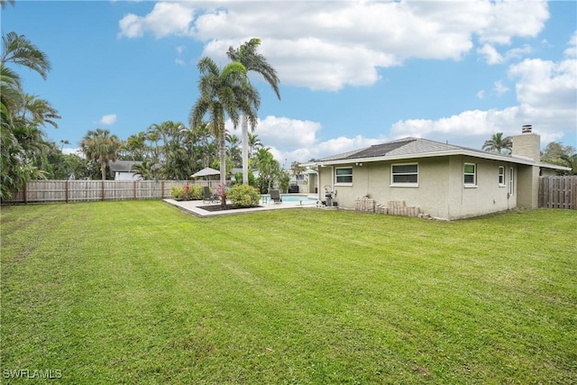 view of yard featuring a fenced in pool, a patio area, and a fenced backyard