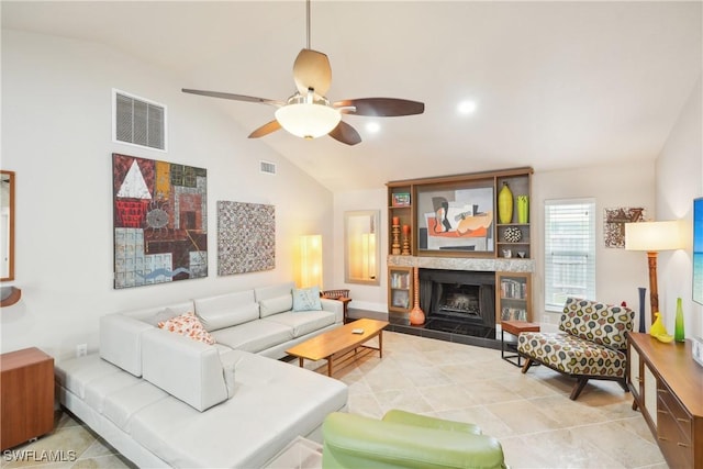 living area with a ceiling fan, a tile fireplace, tile patterned flooring, and visible vents