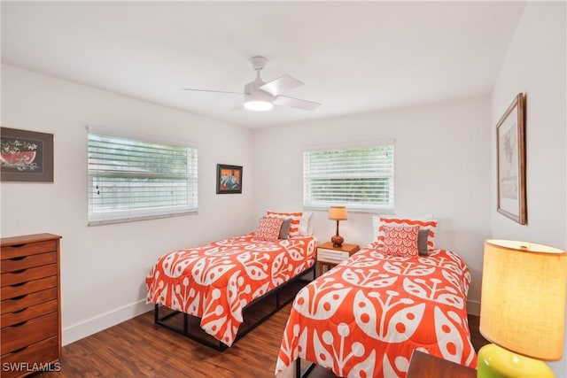 bedroom featuring a ceiling fan, baseboards, and wood finished floors