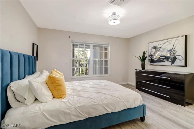 bedroom featuring light wood-style floors, baseboards, and visible vents