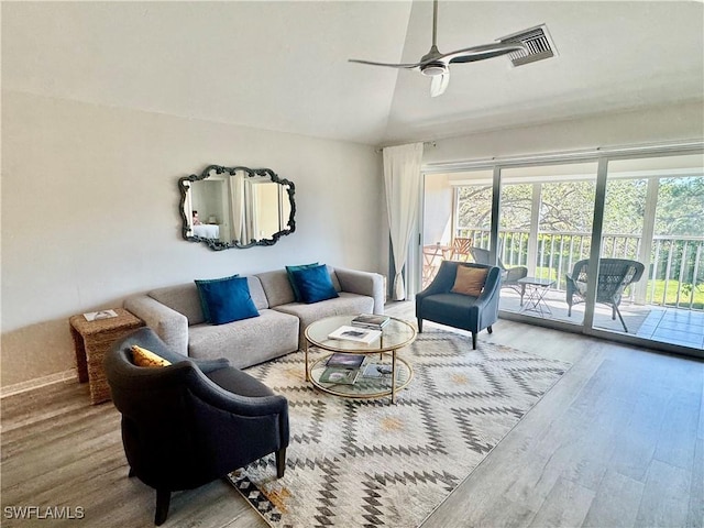 living room with lofted ceiling, ceiling fan, and wood finished floors