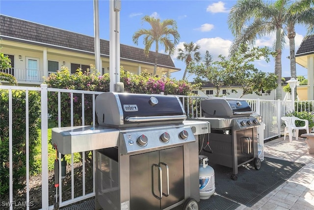 view of patio featuring fence and area for grilling