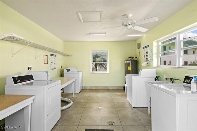 shared laundry area featuring light tile patterned flooring, independent washer and dryer, electric water heater, and a ceiling fan