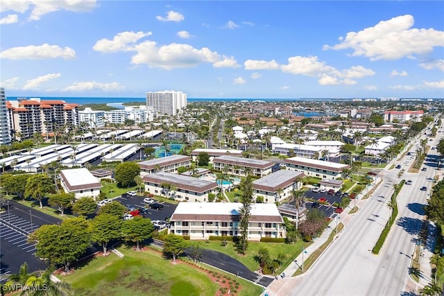 drone / aerial view featuring a water view and a view of city