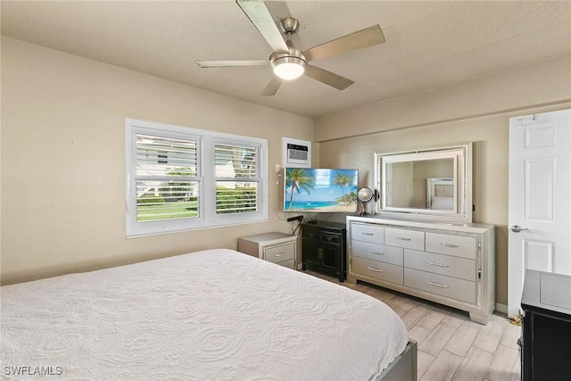 bedroom with light wood-style flooring and a ceiling fan