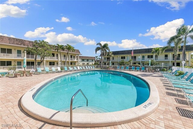 pool featuring a residential view, fence, and a patio