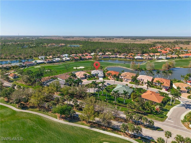 birds eye view of property featuring golf course view, a water view, and a residential view