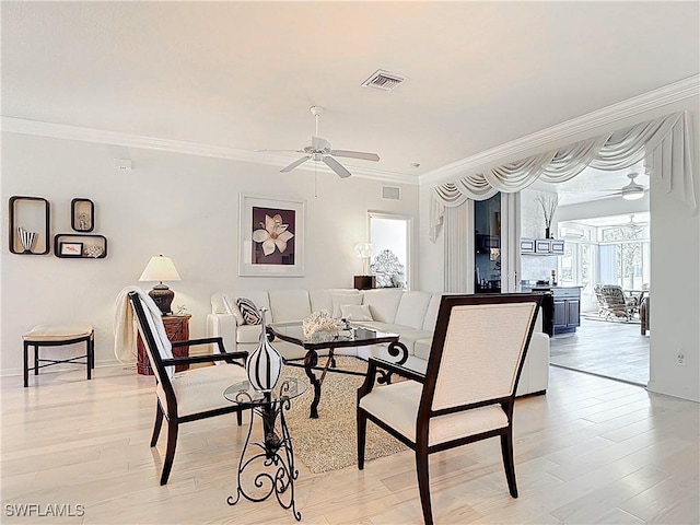 dining room featuring visible vents, a ceiling fan, and light wood-style floors