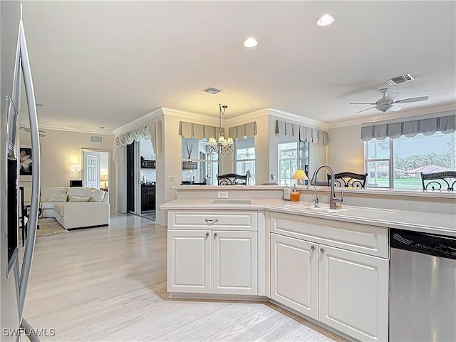 kitchen featuring visible vents, ornamental molding, a sink, light countertops, and dishwasher