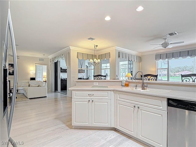 3519 Barnstable Ct, North Fort Myers, FL 33917 - kitchen with appliances with stainless steel finishes, a sink, a chandelier, light countertops, and white cabinets