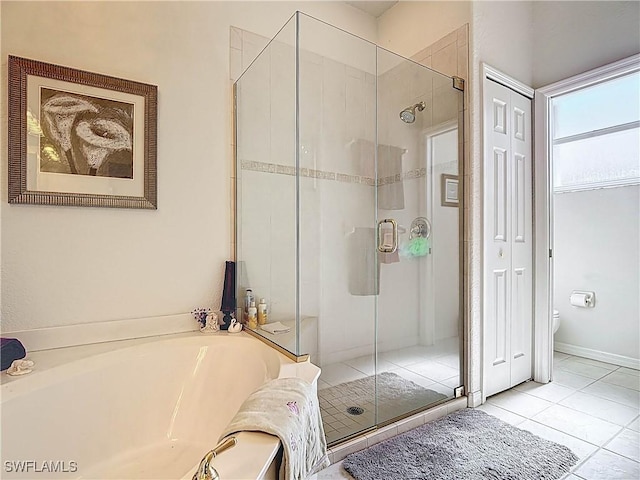 full bath featuring tile patterned flooring, a garden tub, toilet, and a shower stall