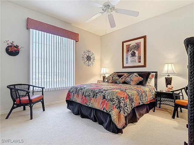 bedroom featuring baseboards, a ceiling fan, and carpet flooring