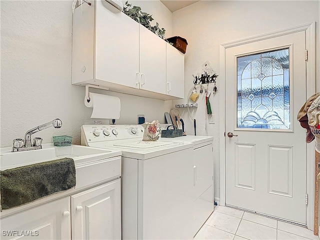 3519 Barnstable Ct, North Fort Myers, FL 33917 - laundry area featuring cabinet space, washer and clothes dryer, light tile patterned floors, and a textured wall