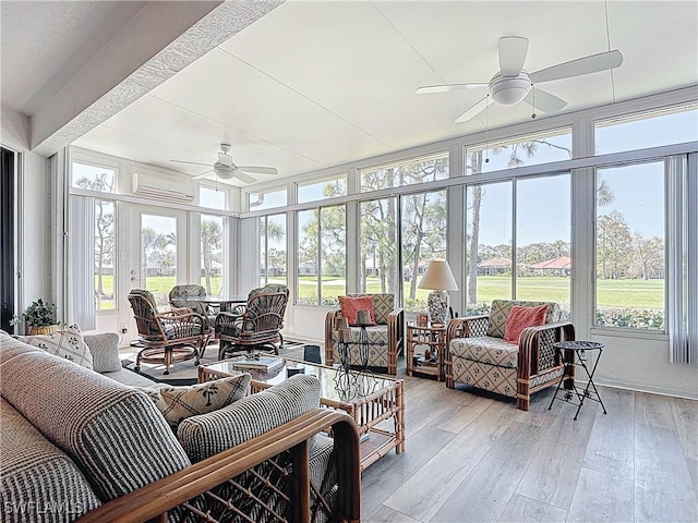 sunroom / solarium featuring an AC wall unit and a ceiling fan