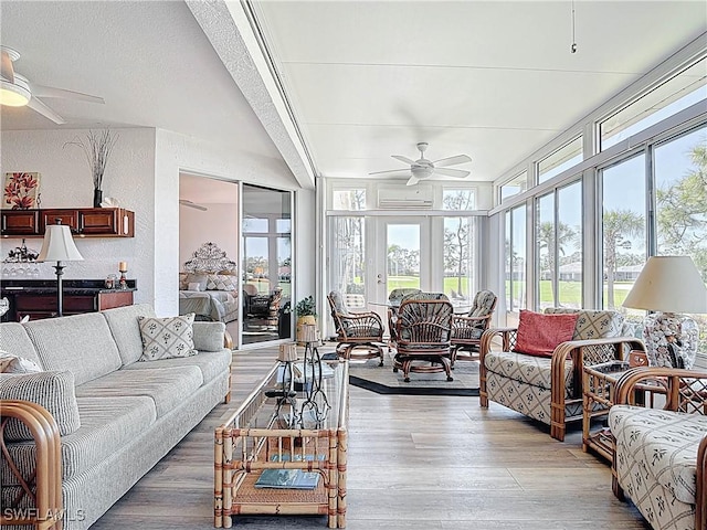 living area with light wood-style flooring, a ceiling fan, and a textured wall