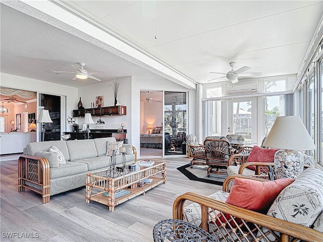 living area with a wealth of natural light, light wood-type flooring, and ceiling fan