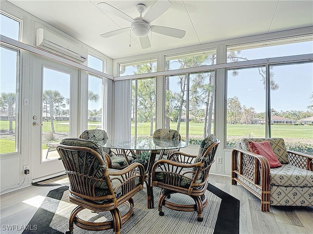 sunroom with a wall unit AC and ceiling fan